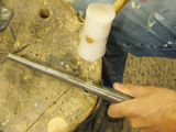 Form ring on mandrill with nylon hammer